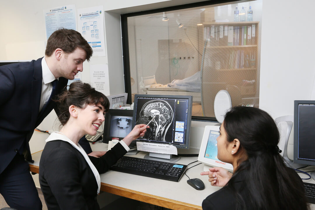 Members of the multidisciplinary team discuss an MRI scan